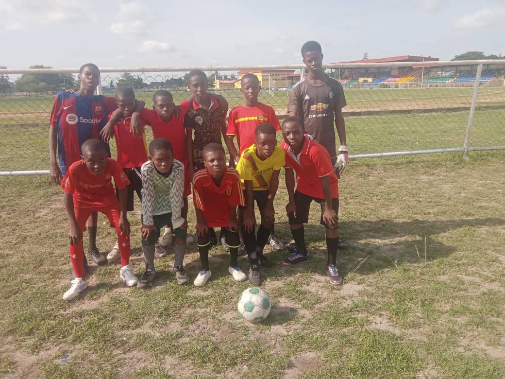 Junior team posing together after a friendly match