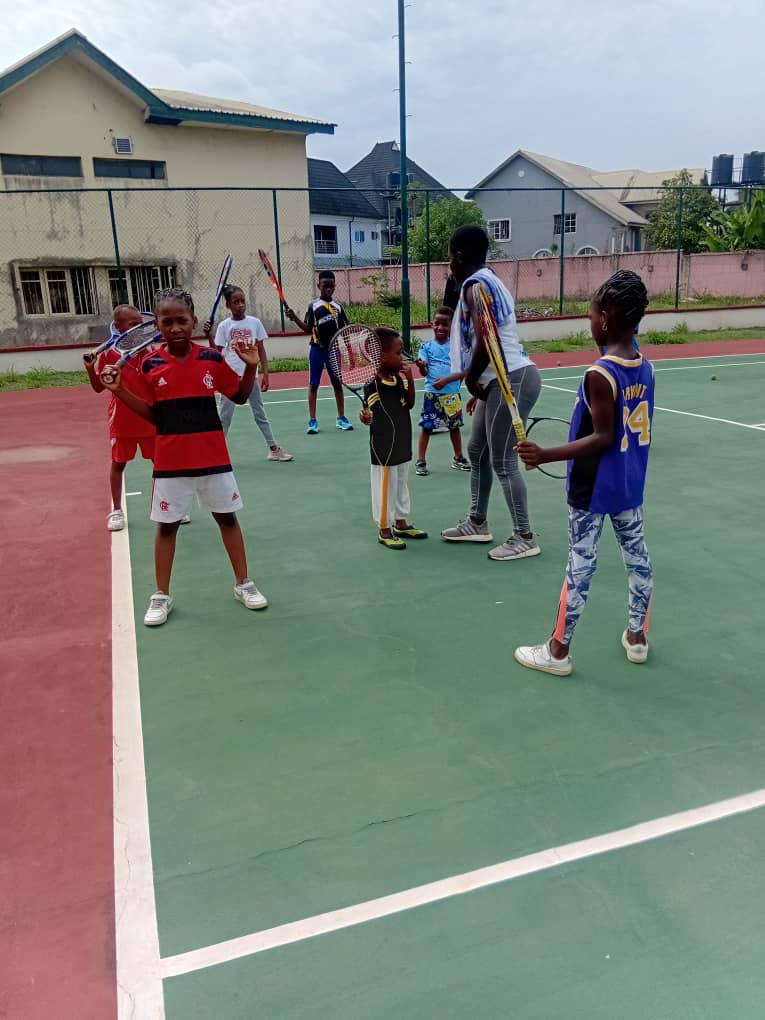 Children in a tennis coaching session at the academy