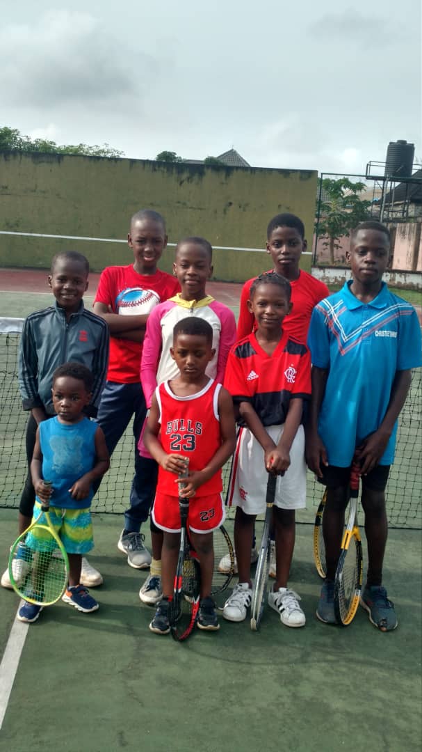 Young tennis players holding rackets on court